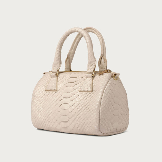 Beige textured handbag on a light gray background